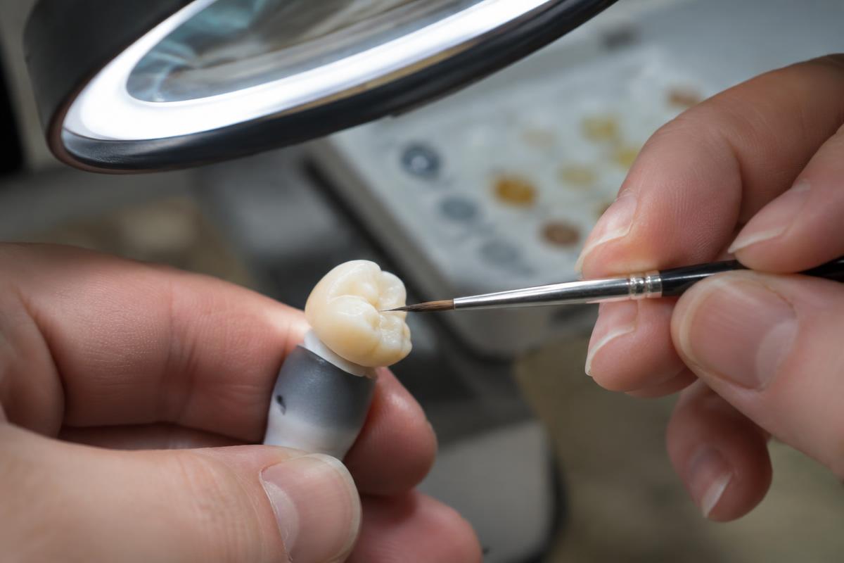 Technician finishing a ceramic crown